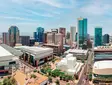 Panoramic view of downtown Phoenix, Arizona with skyscrapers, convention center, and clear view of the surrounding landscape.