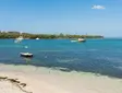 Coastline in Fajardo, Puerto Rico, with turquoise water, sandy beach, and small anchored boats.