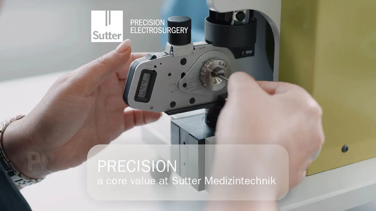 Close-up of hands adjusting precision measuring device at Sutter Medizintechnik