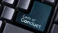 Nahaufnahme einer Computertastatur mit einer hervorgehobenen petrolfarbenen Taste, auf der „Code of Conduct“ steht.