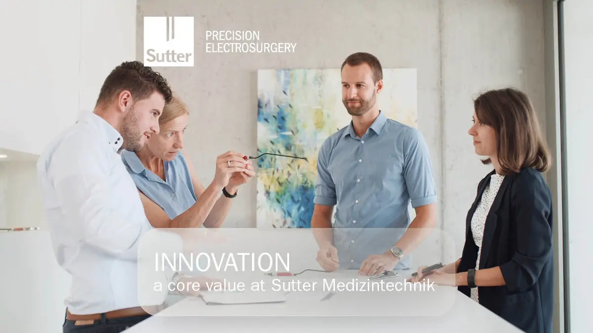 Team of four people discussing innovation at Sutter Medizintechnik, holding a precision instrument